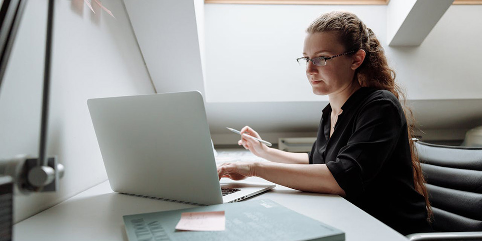 Studentkinja sedi u svojoj sobi i uči